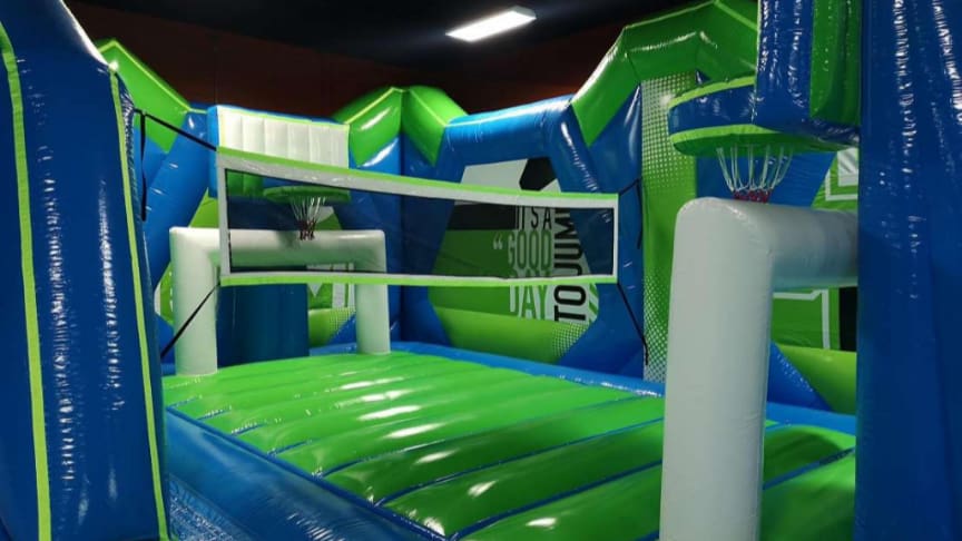 Inflatable volleyball net and basketball hoop inside Play and Spin bounce park in Niles Illinois