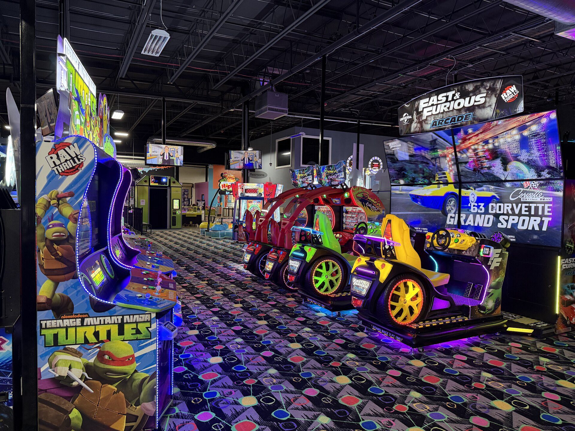 Play and Spin arcade floor with rows of games in Niles