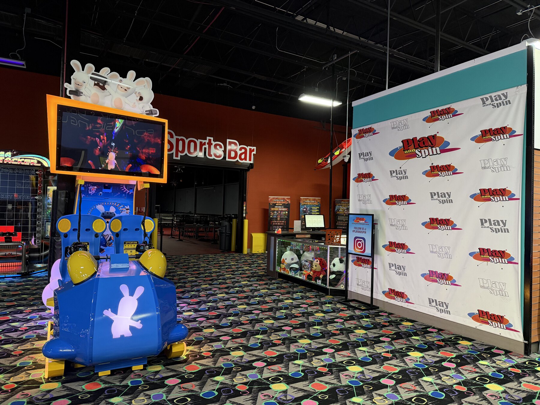 Arcade floor, sports bar sign, and Play and Spin event photo backdrop in Niles Illinois